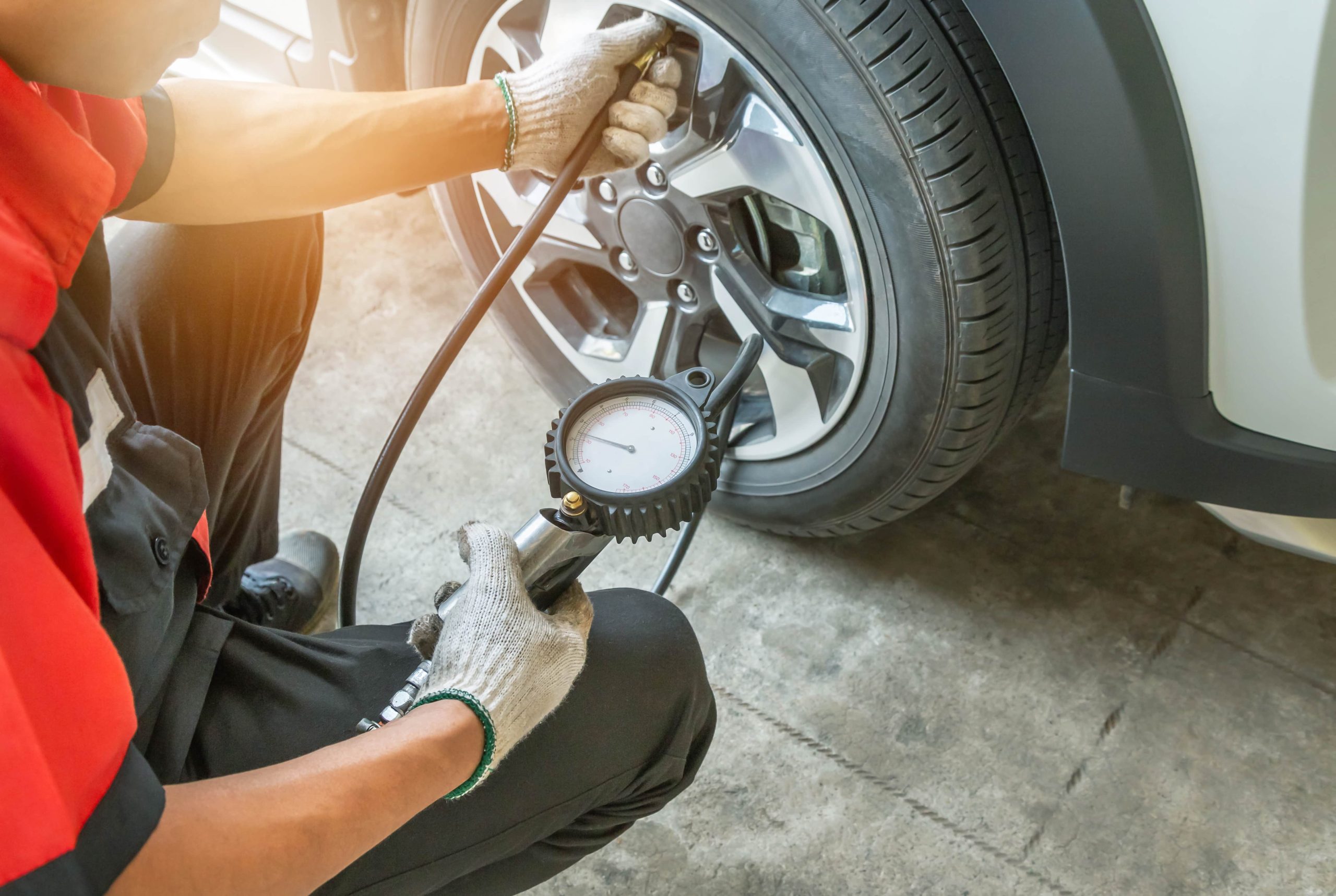 Technician checking a vehicle's tire pressure