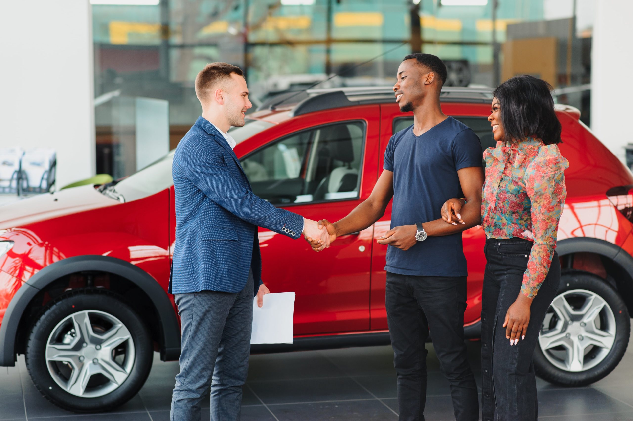 car salesman shaking hands with a client