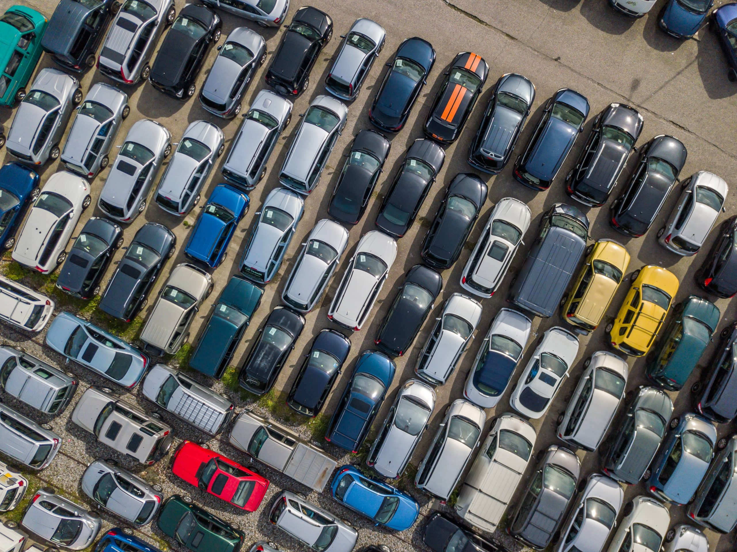 Used cars parked in a parking lot - aerial view