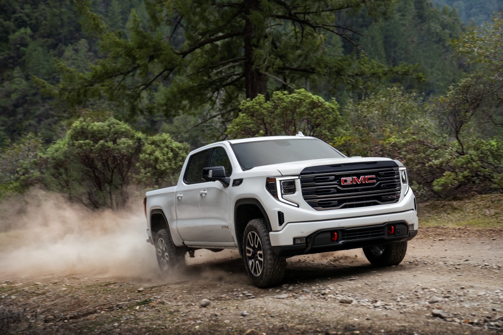White 2026 GMC Sierra 1500 AT4 driving offroad