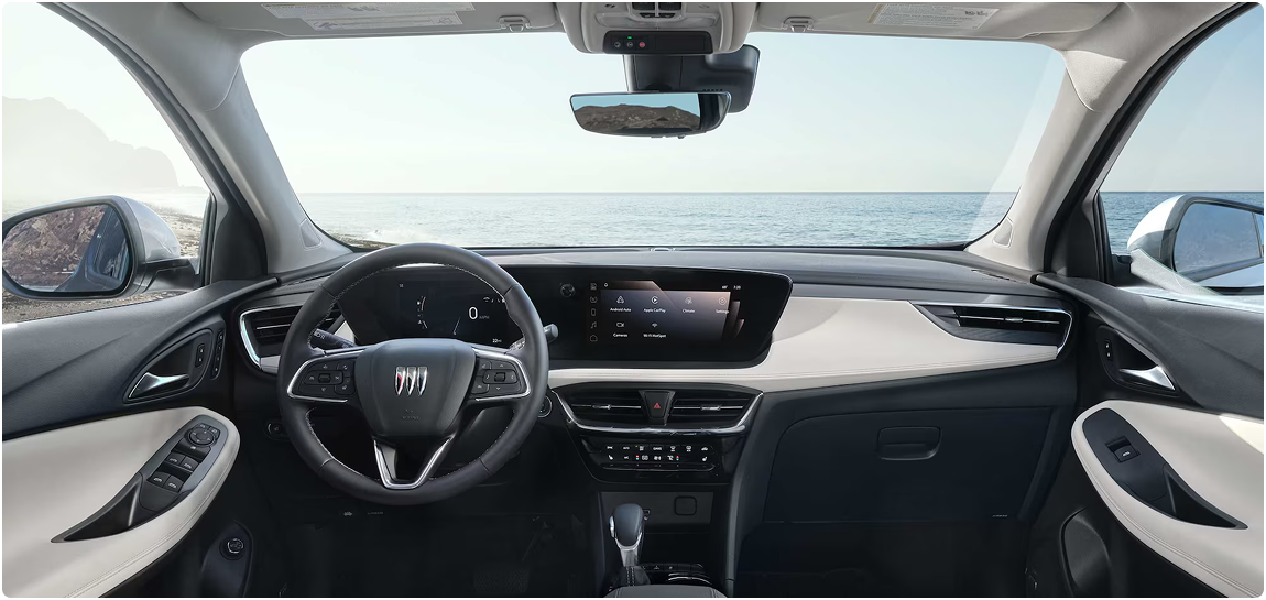 Encore GX dashboard and steering wheel seen from the rear seat, the sea visible through the windshield