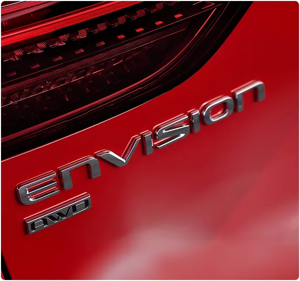 Close-up of the Envision AWD badge and tail lamp on a red Buick Envision
