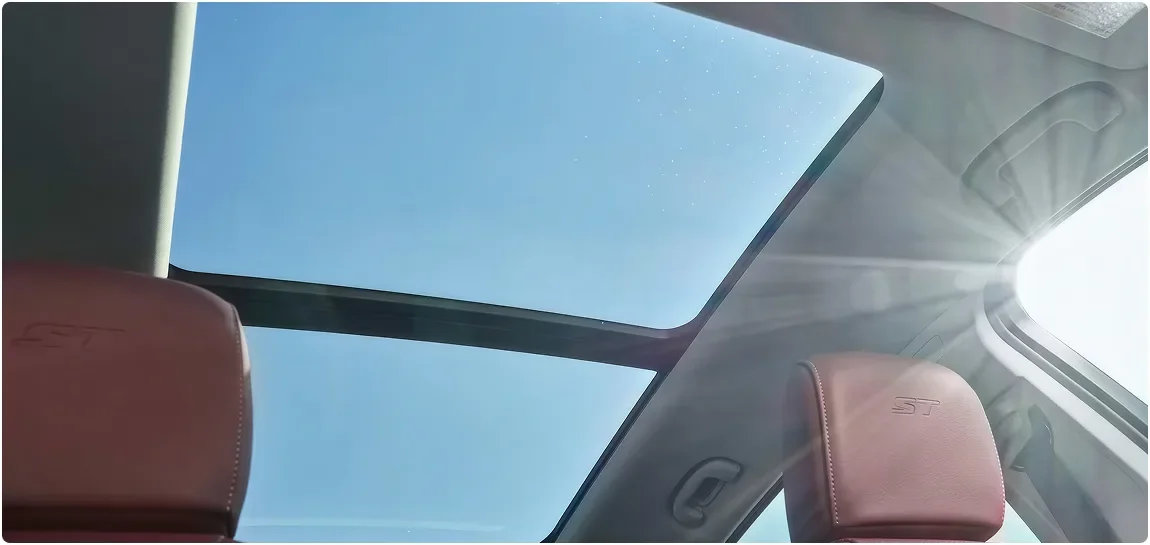 Open panoramic moonroof seen from inside the Envision above burgundy seats