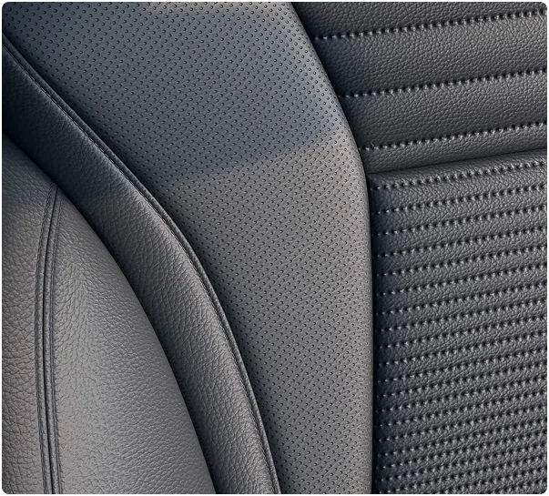 Close-up of a black perforated leather seat bolster inside the Buick Envision