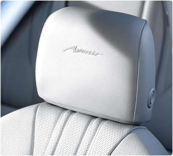 Light grey front seat with an Avenir-embossed headrest inside the Buick Envision