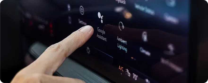 Finger selecting an app on the Buick Envision ultrawide touchscreen
