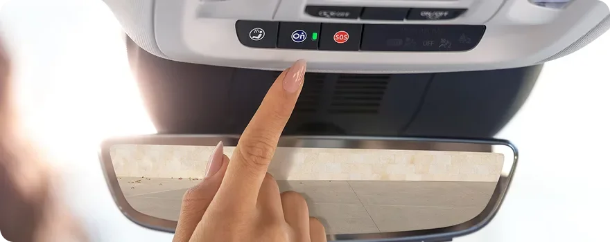 Finger pressing the OnStar buttons on the Buick Envision overhead console