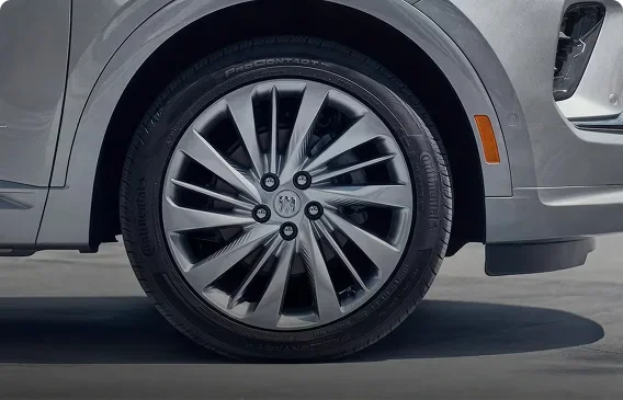 Close-up of a 20-inch Pearl Nickel finish alloy wheel on a silver Buick Envision Avenir