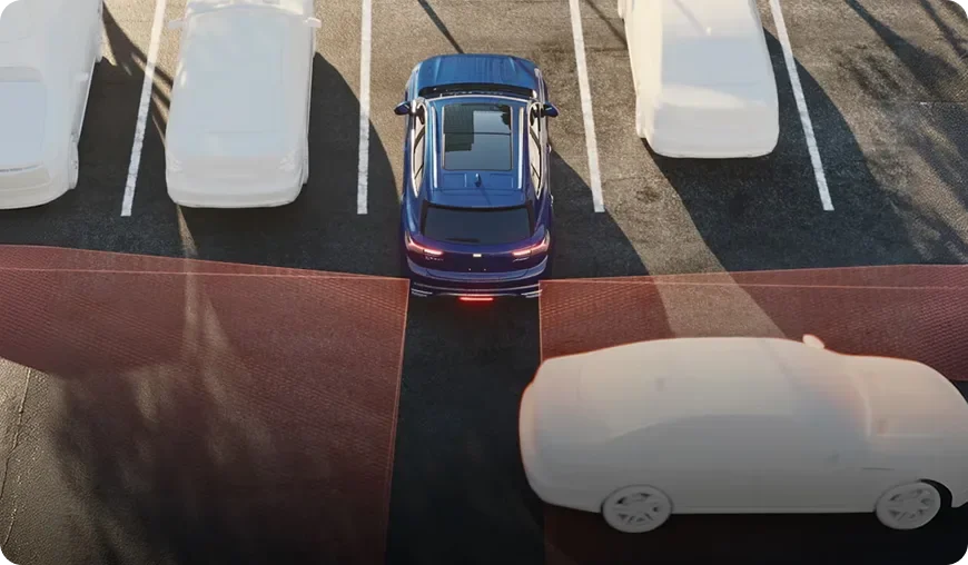 Overhead illustration of a blue Envision reversing from a parking space with a red zone marking crossing traffic