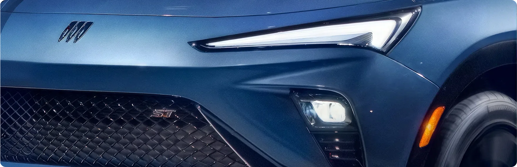 Close-up of the front of a blue Buick Envista showing its check-shaped LED daytime running lamps