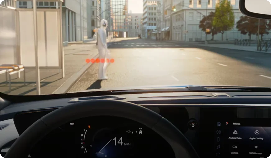 Driver's view through the Envista windshield of a pedestrian crossing ahead, marked by a red alert