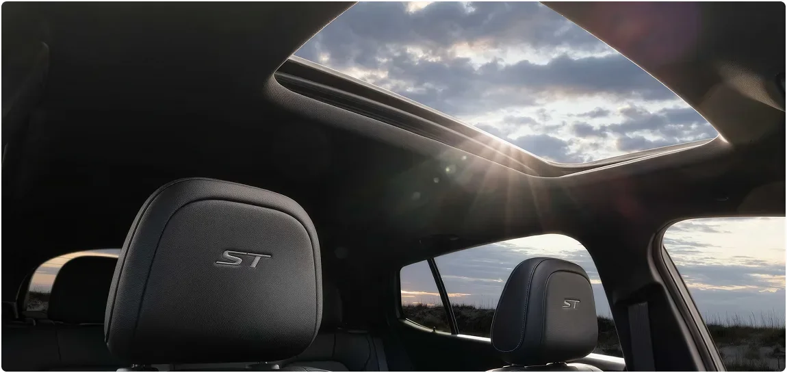 Sport Touring front seats with ST headrests beneath the Envista's open moonroof at sunset
