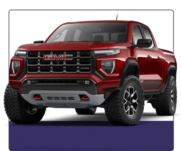 Red GMC Canyon AT4X shown from the front three-quarter angle on a dark studio background