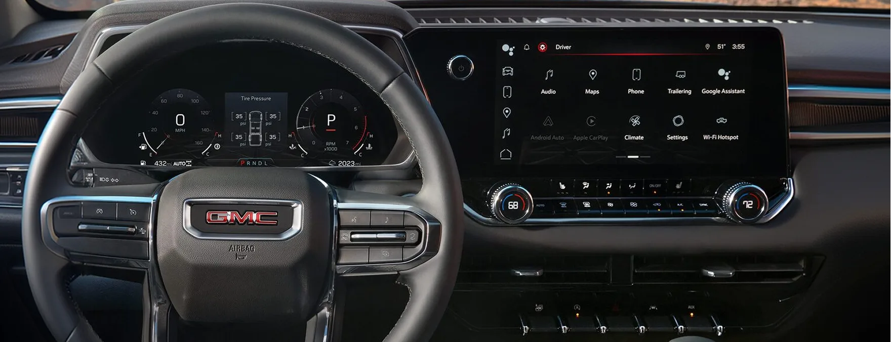 The Canyon's driver display and centre touchscreen with desert bluffs through the windshield