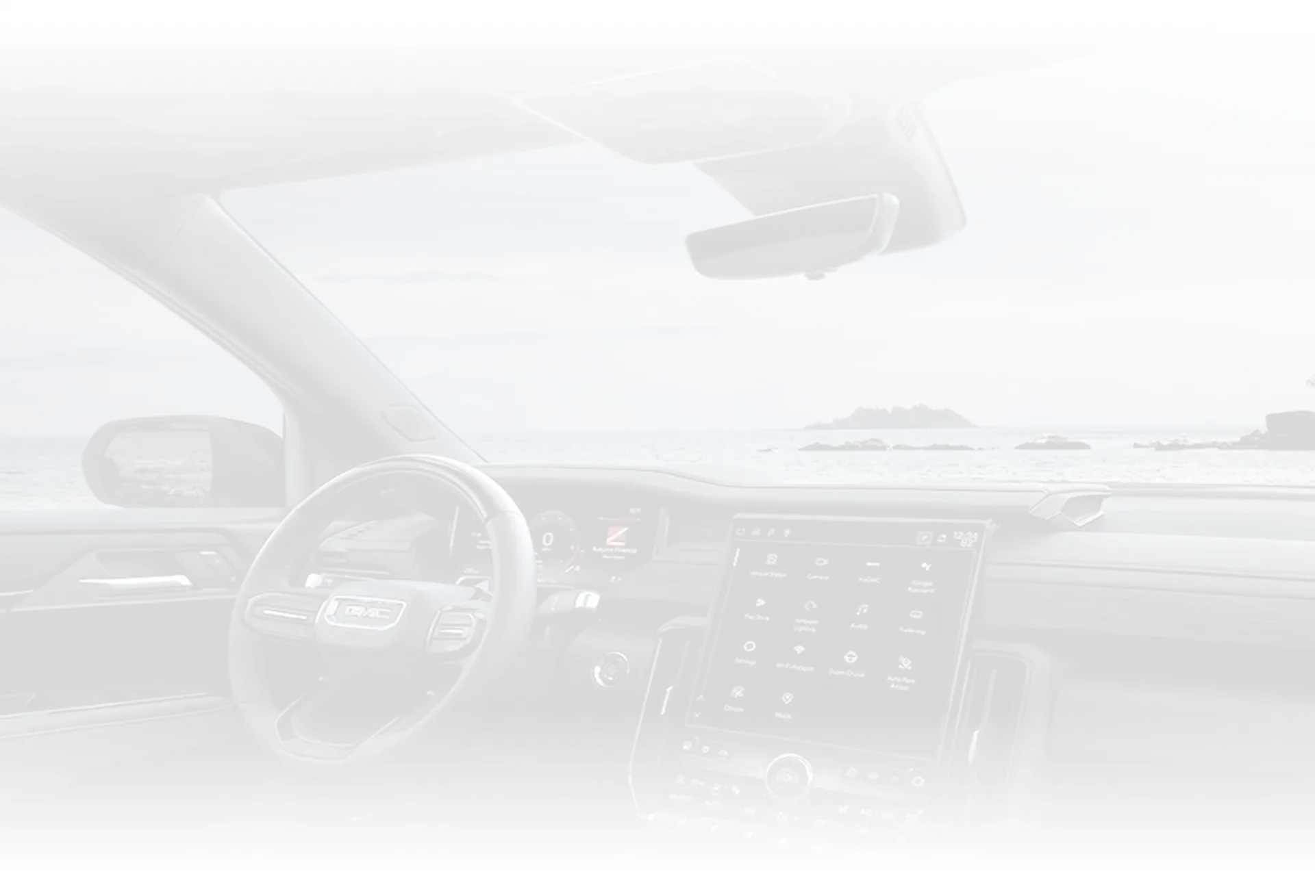 Faint backdrop of the GMC Canyon's dashboard and centre touchscreen