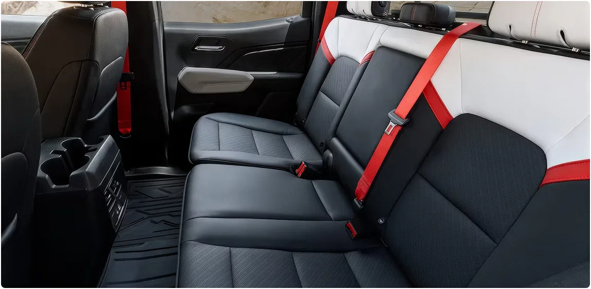 The Canyon AT4X's rear bench seats with red seatbelt harnesses
