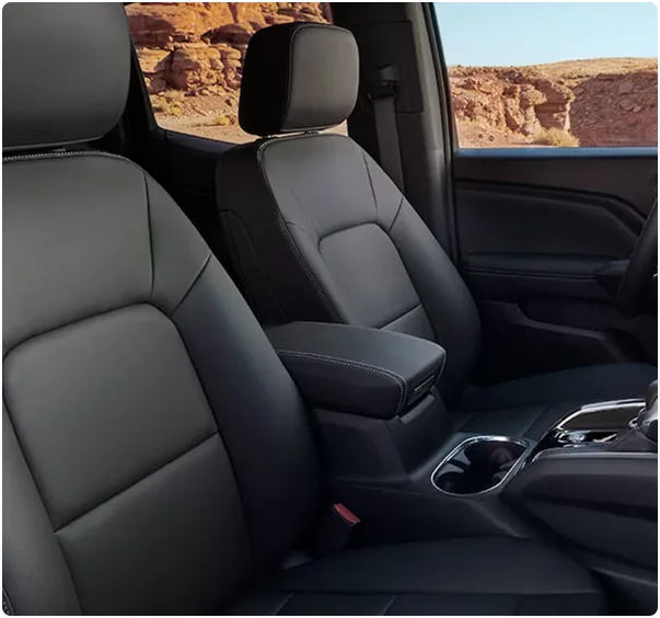 The Canyon's black leather front seats with red desert rock through the side window
