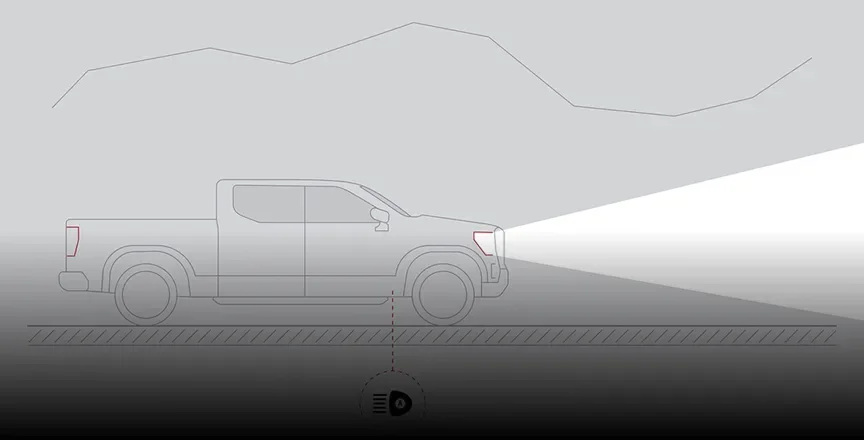 Illustration of a Canyon on a dark road with a wide beam showing the high beams lit by IntelliBeam