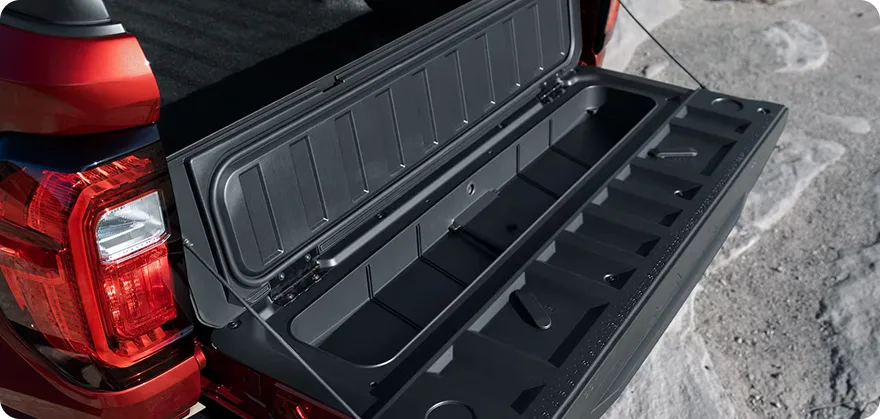 The Canyon's MultiStow tailgate folded open to show its integrated storage compartment