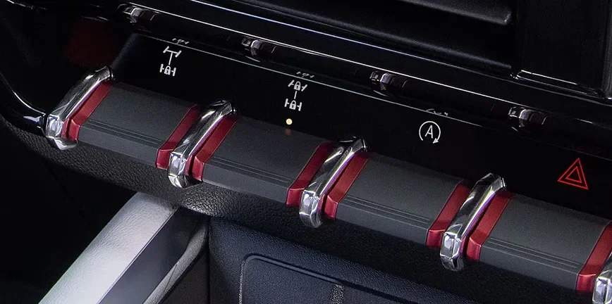 Close-up of the Canyon's overhead auxiliary switch bank with red-tipped toggles
