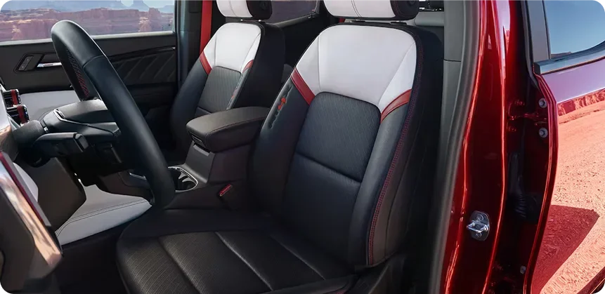 The Canyon AT4X's black and red front seats with the driver's door open