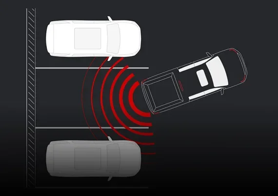 Overhead illustration of a Canyon reversing into a parking space with red arcs for Rear Park Assist