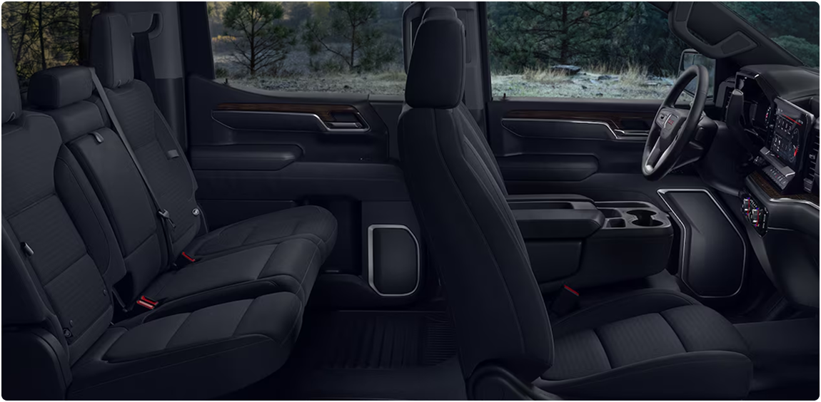 Black leather front and rear seats in a GMC Sierra 1500 Crew Cab, seen through the open doors
