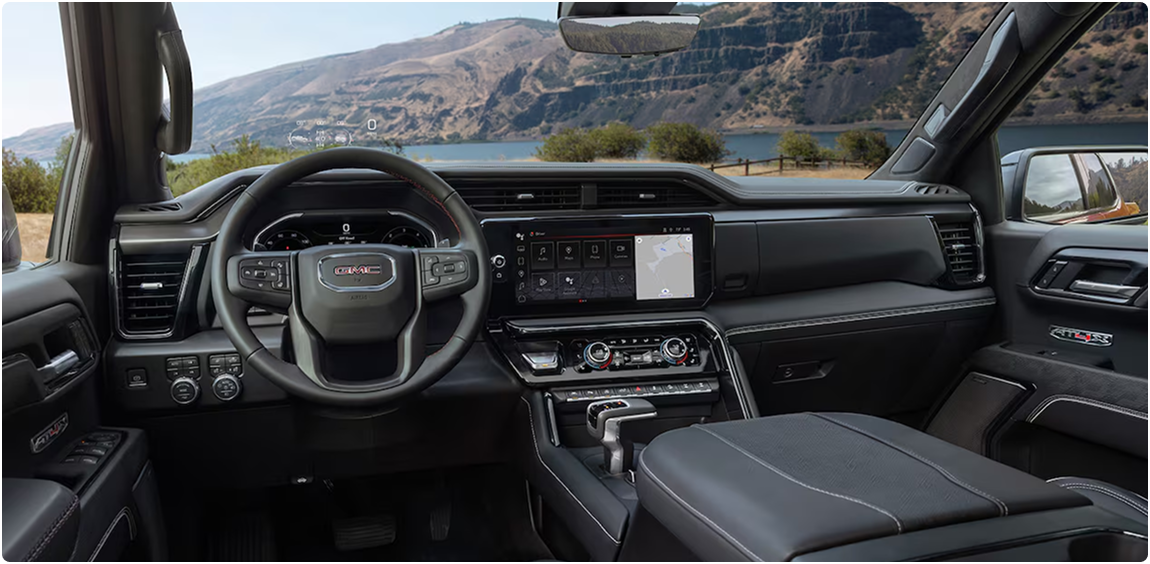 GMC Sierra 1500 dashboard and steering wheel with rolling hills visible through the windshield