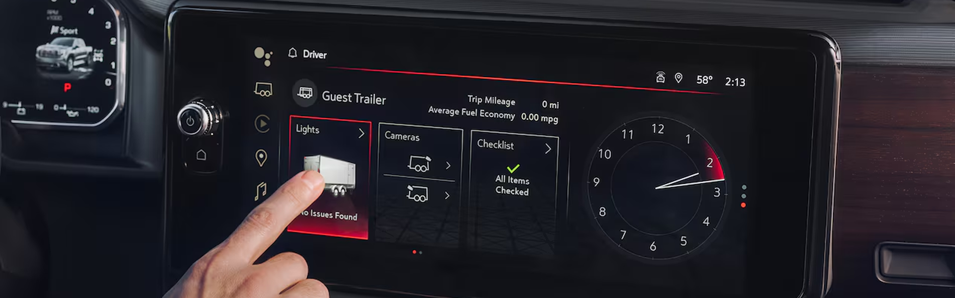 Finger selecting the trailer lights test on the GMC Sierra 1500 touchscreen trailering app