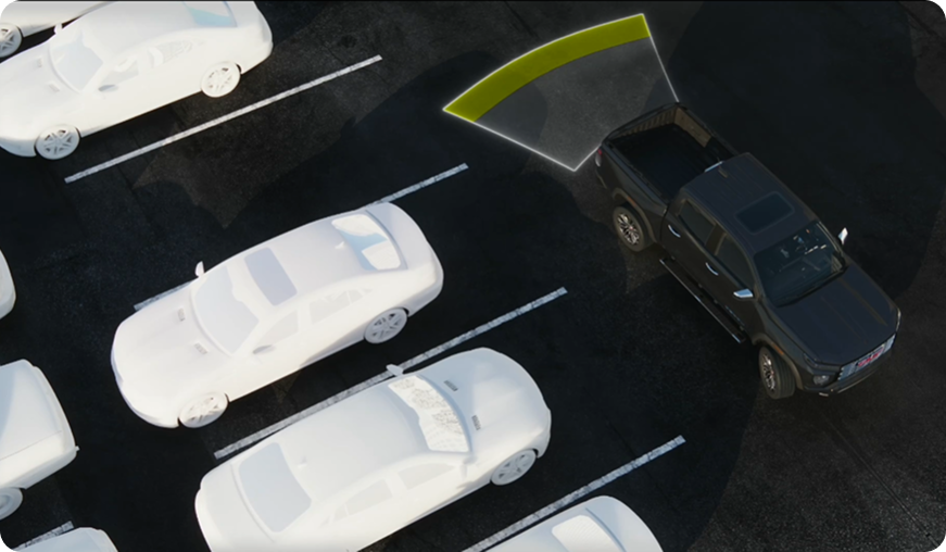 Illustration of a black GMC truck backing into a parking space, with a sensor zone behind it