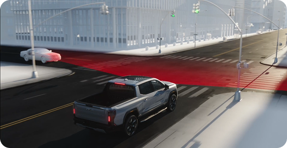 Illustration of a silver GMC truck stopping at an intersection as a car crosses in front, the crossing path marked in red