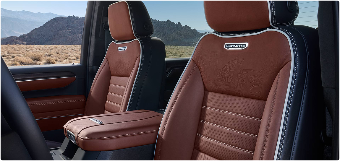 Brown leather front seats with Ultimate badges in the GMC Sierra HD Denali Ultimate