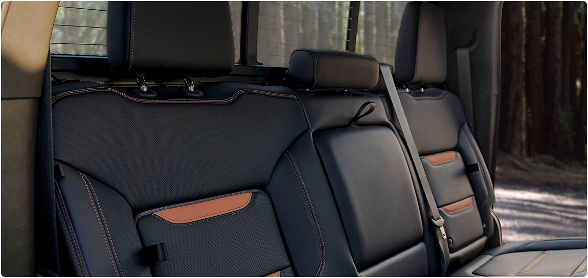 Black leather rear seats with orange accents in a GMC Sierra HD Crew Cab