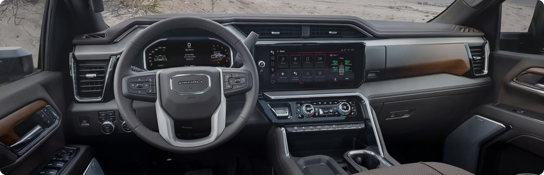 GMC Sierra HD Denali dashboard with wood trim, steering wheel and wide center touchscreen