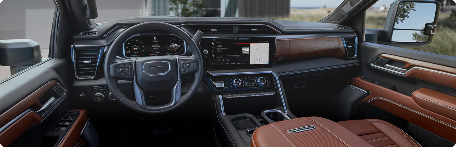 GMC Sierra HD Denali Ultimate dashboard and steering wheel with Alpine Umber brown leather on the console and door