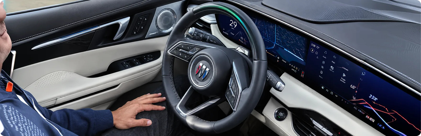 Driver with hands off the wheel using Super Cruise in the Enclave