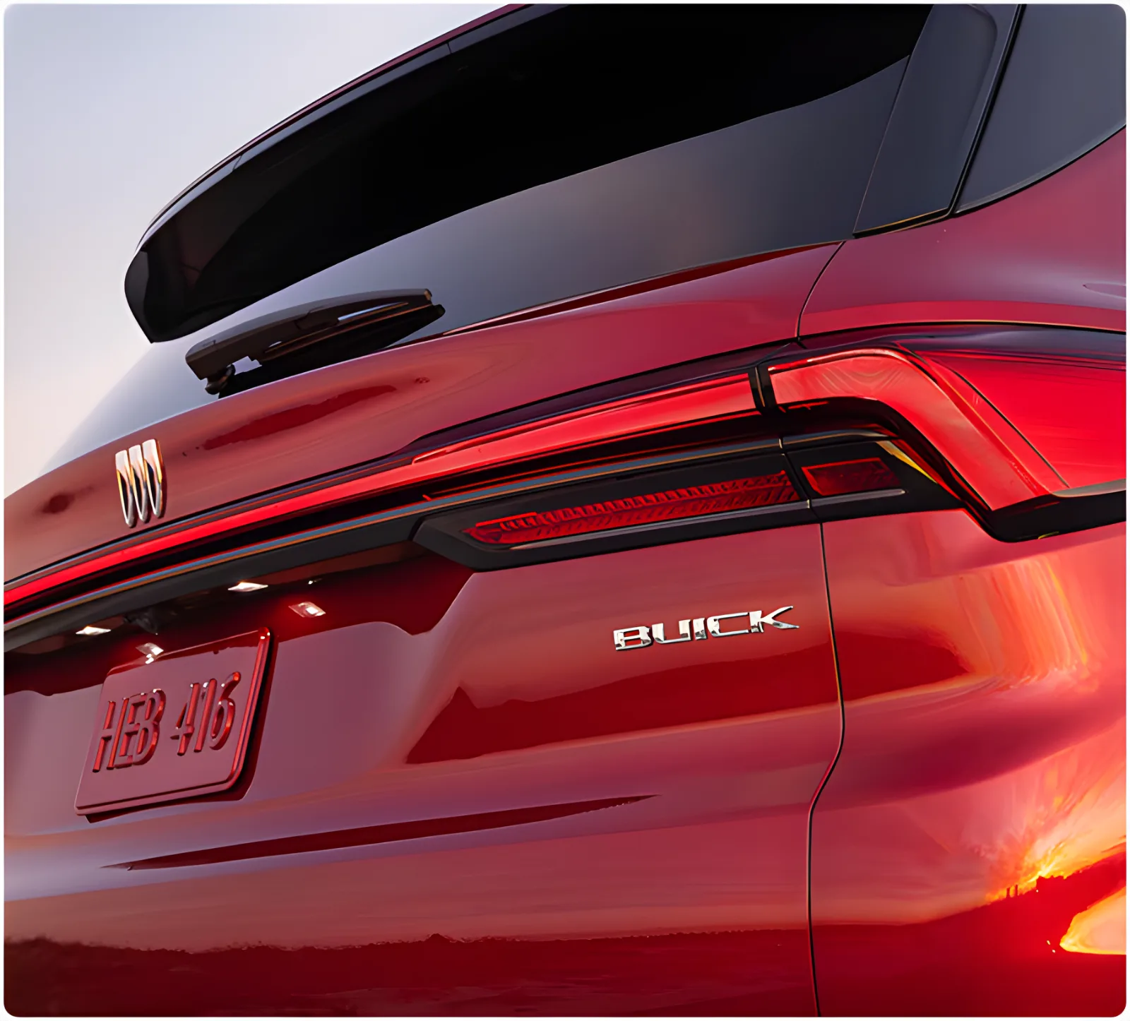 Close-up of the illuminated rear light bar on a red Buick Enclave