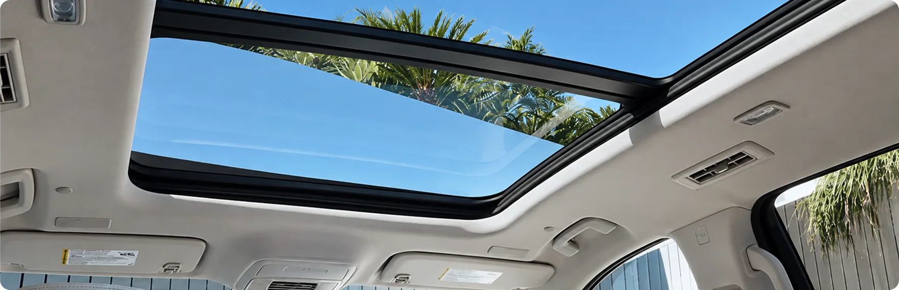 Open panoramic power sunroof seen from inside the Enclave cabin