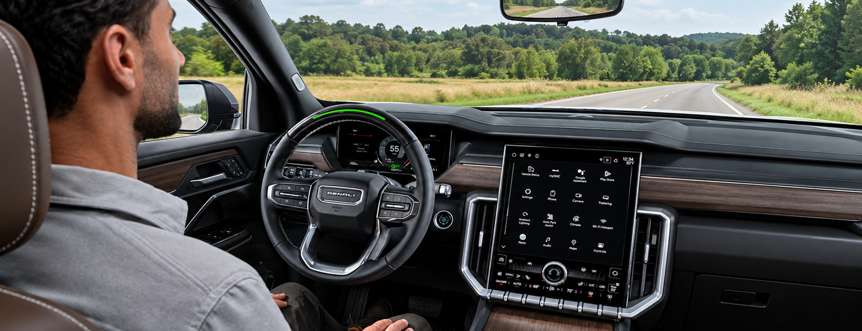 Driver riding hands-free with Super Cruise in a GMC Acadia Denali, the steering wheel light bar glowing green