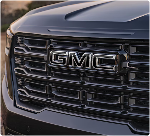 Close-up of the dark grille and GMC emblem on an Acadia