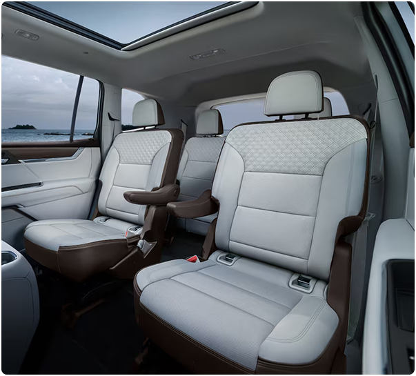 Light gray quilted leather second-row captain’s chairs under a panoramic sunroof in the Acadia Denali