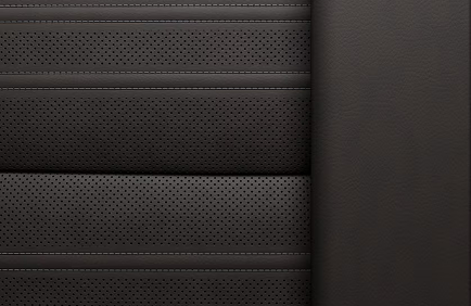 Close-up of dark perforated leather seat panels in the Acadia Denali Ultimate