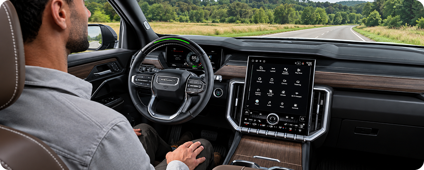 Driver riding hands-free with Super Cruise in a GMC Acadia Denali on a country road