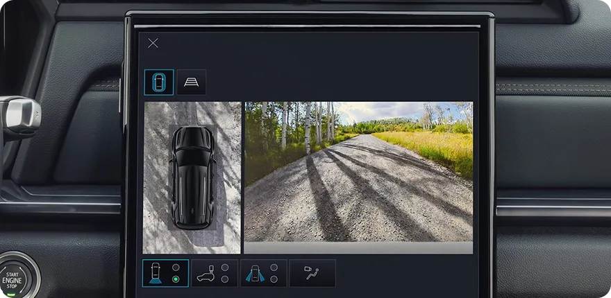 The 2027 GMC Terrain's touchscreen showing an overhead HD Surround Vision view beside a forward trail camera view