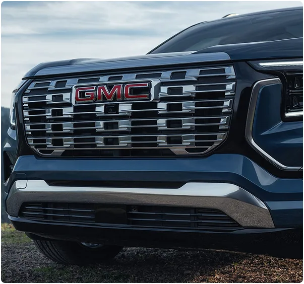 Close-up of the 2027 GMC Terrain Denali's chrome grille and red GMC badge