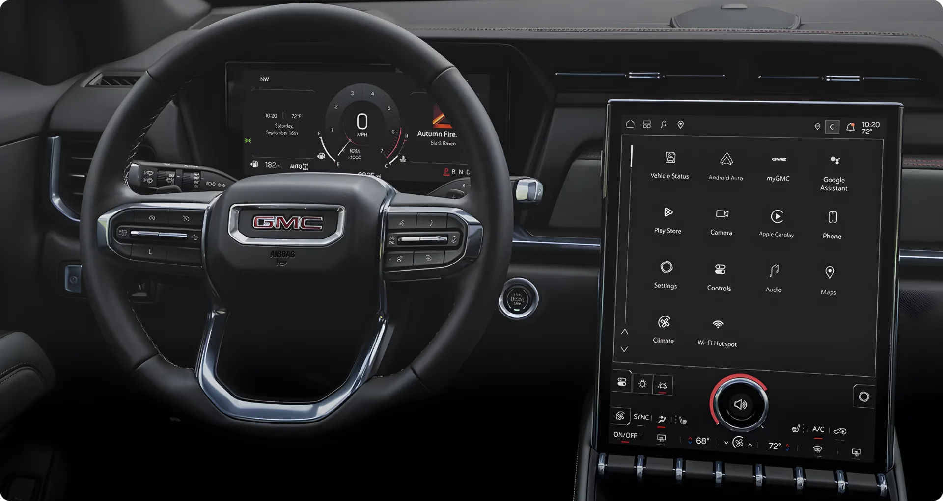 View across the 2027 GMC Terrain's dashboard and vertical touchscreen through the windshield toward a forest