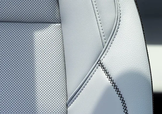 Close-up of the 2027 GMC Terrain Denali's light perforated leather-appointed front seat with contrast stitching