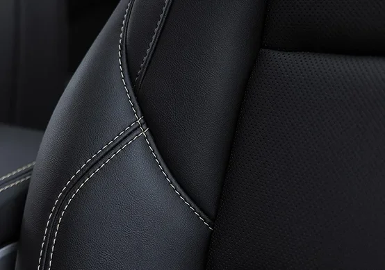 Close-up of the 2027 GMC Terrain Elevation's black premium cloth front seat with perforated panels and contrast stitching