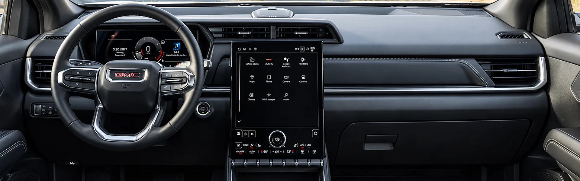 Wide view of the 2027 GMC Terrain's instrument panel with the steering wheel, digital driver display and vertical touchscreen
