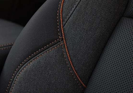 Close-up of the 2027 GMC Terrain AT4's Forest Storm cloth and CoreTec seat with copper-toned Mahogany stitching